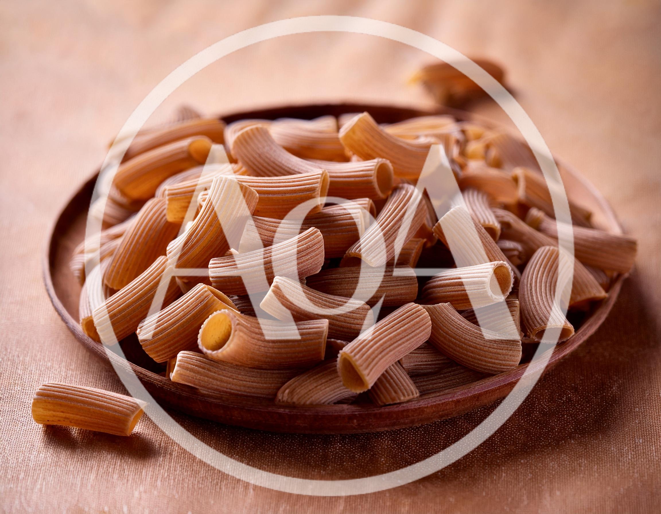 Whole Wheat Rigatoni Pasta On A Wooden Plate