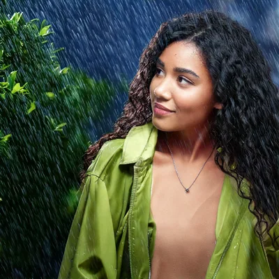 Young Woman Standing Outdoors During A Rainstorm