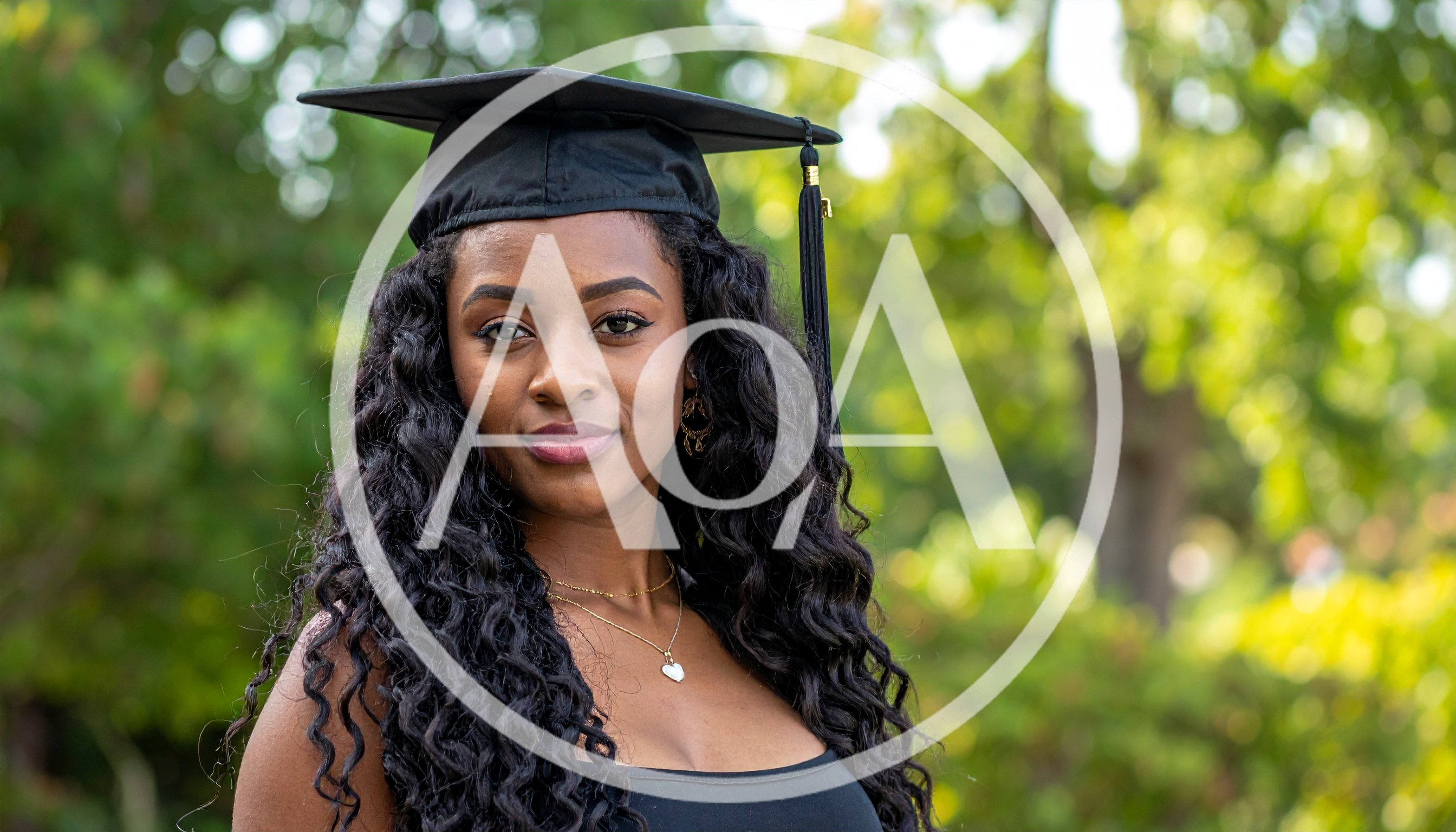 Young African American Woman Wearing Graduation Cap Outdoors