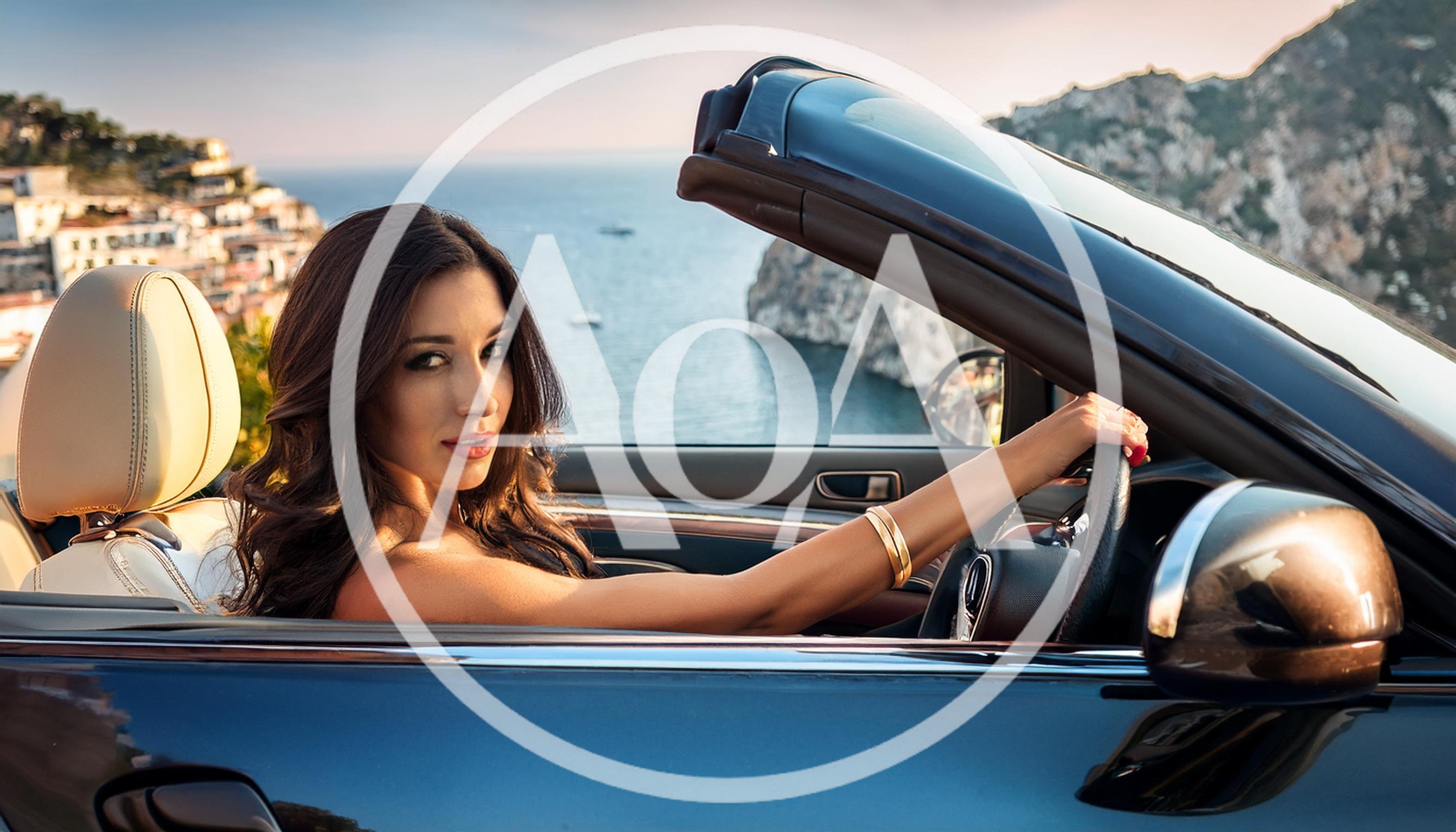 Beautiful Woman Driving A Convertible Along The Amalfi Coast