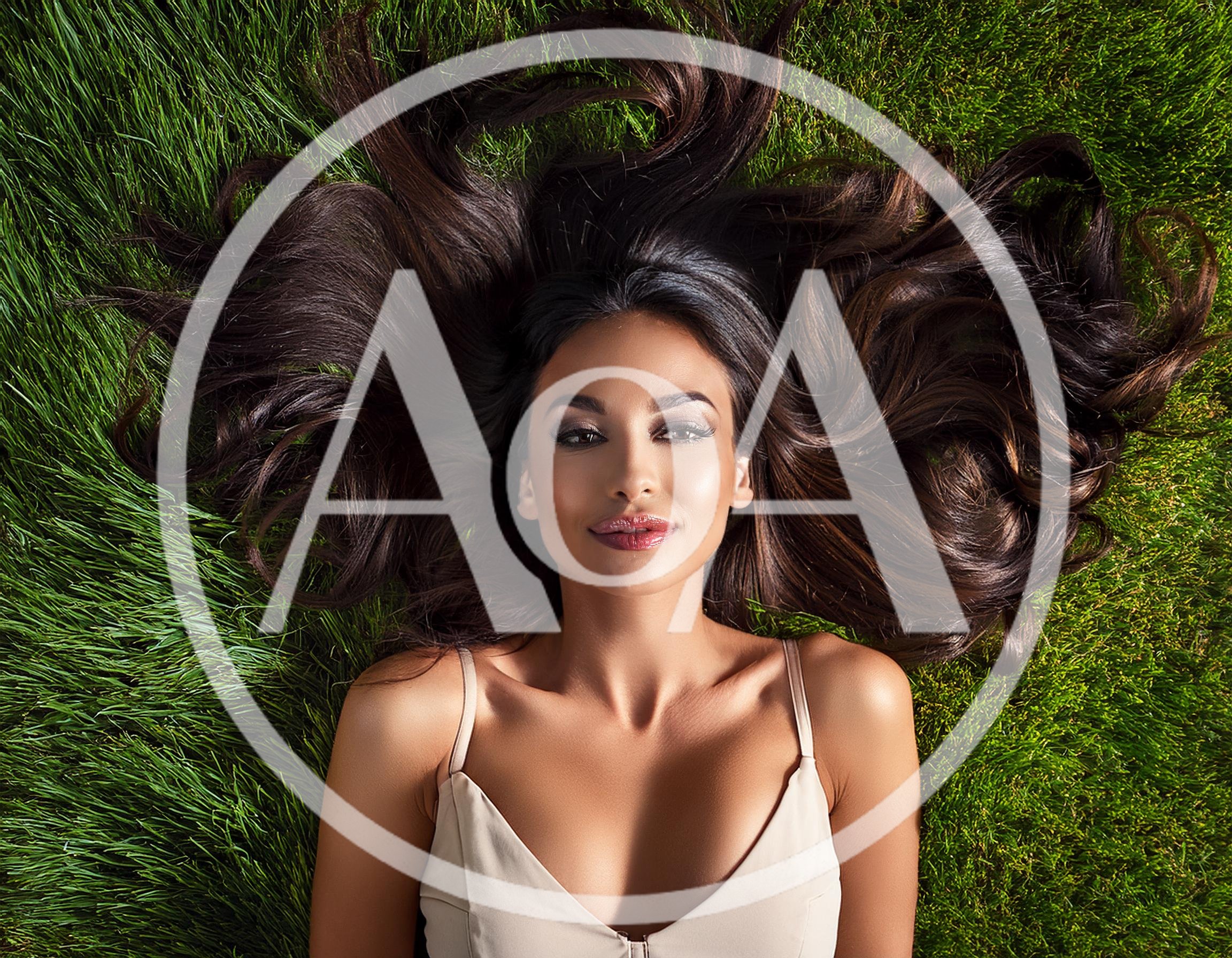 Beautiful Woman With Long Dark Hair Lying On Grass