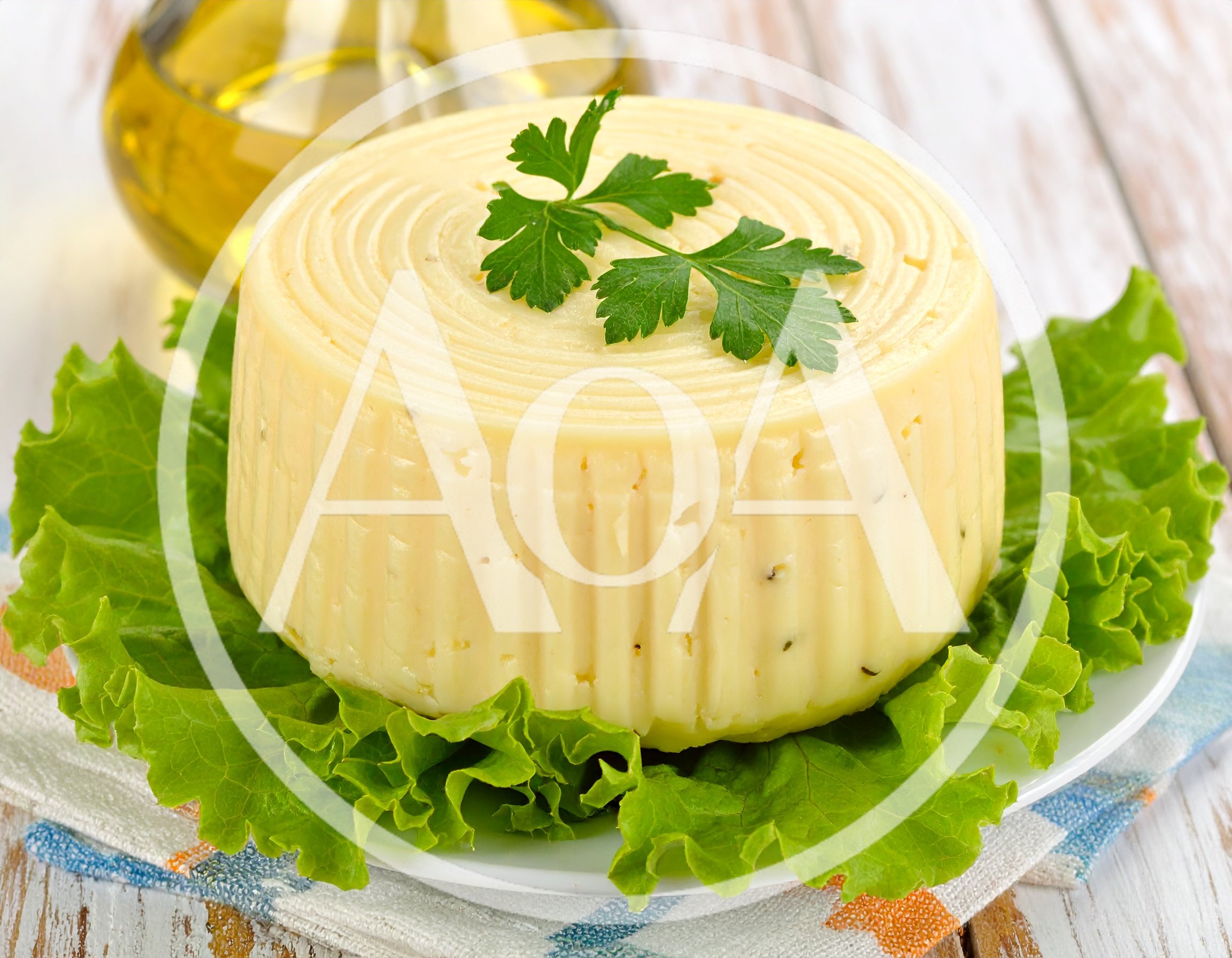 Round Wheel Of Fresh Cheese On Lettuce Leaves