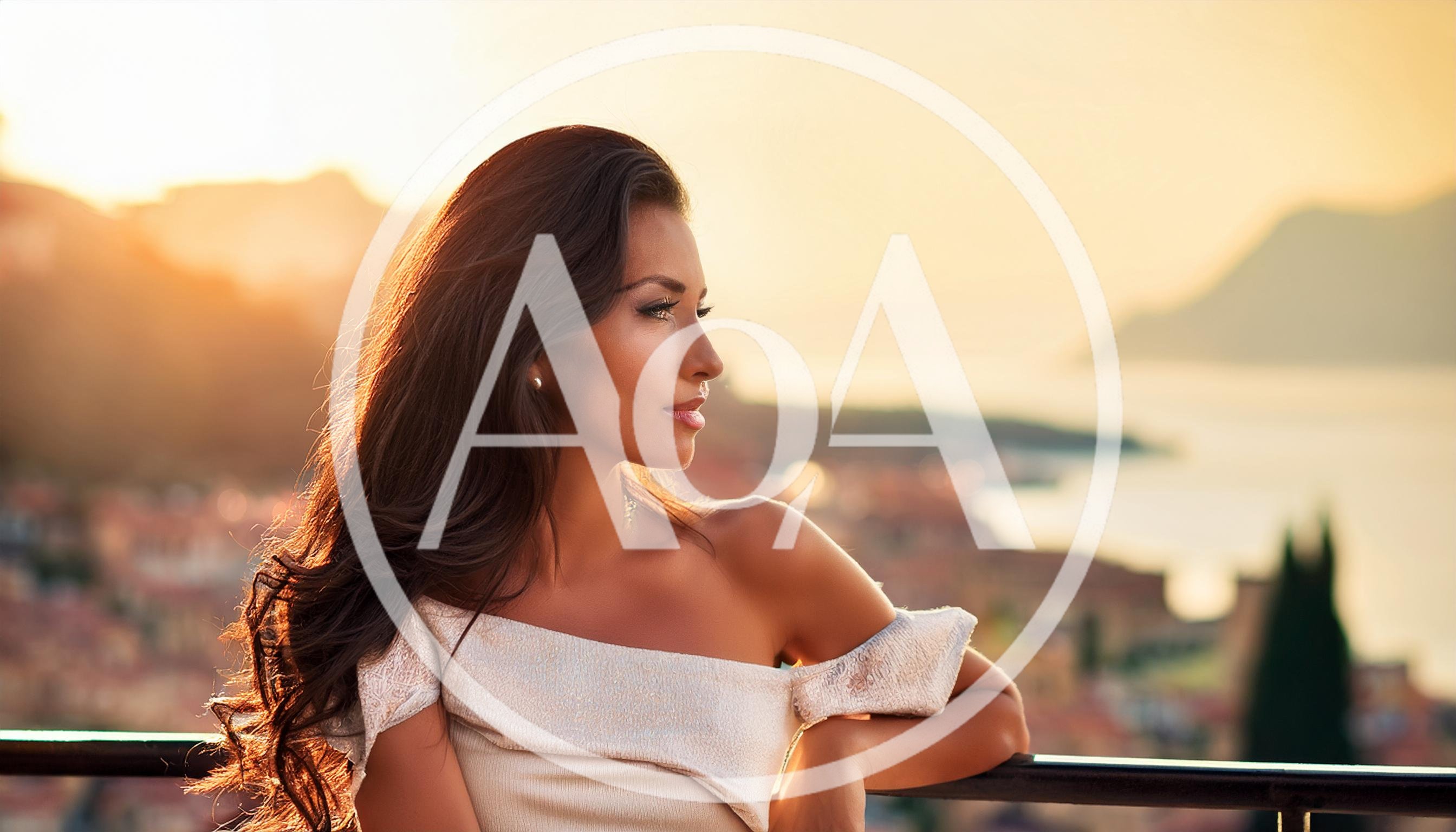 Beautiful Woman Leaning On Railing At Sunset