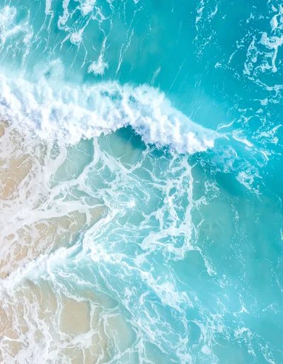 Aerial View Of Turquoise Ocean Waves Crashing On Beach