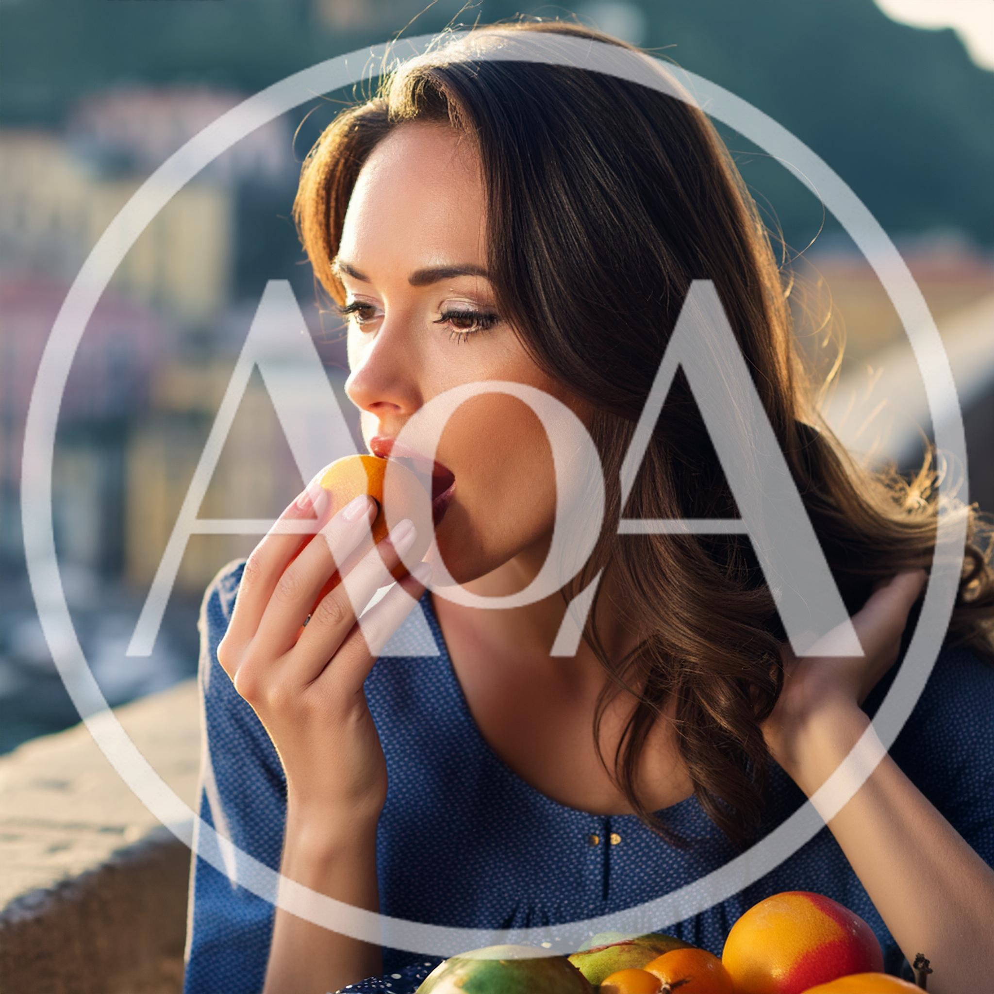 Beautiful Woman Eating A Fresh Orange Outdoors