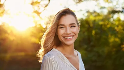 Smiling Young Woman Outdoors During Golden Hour