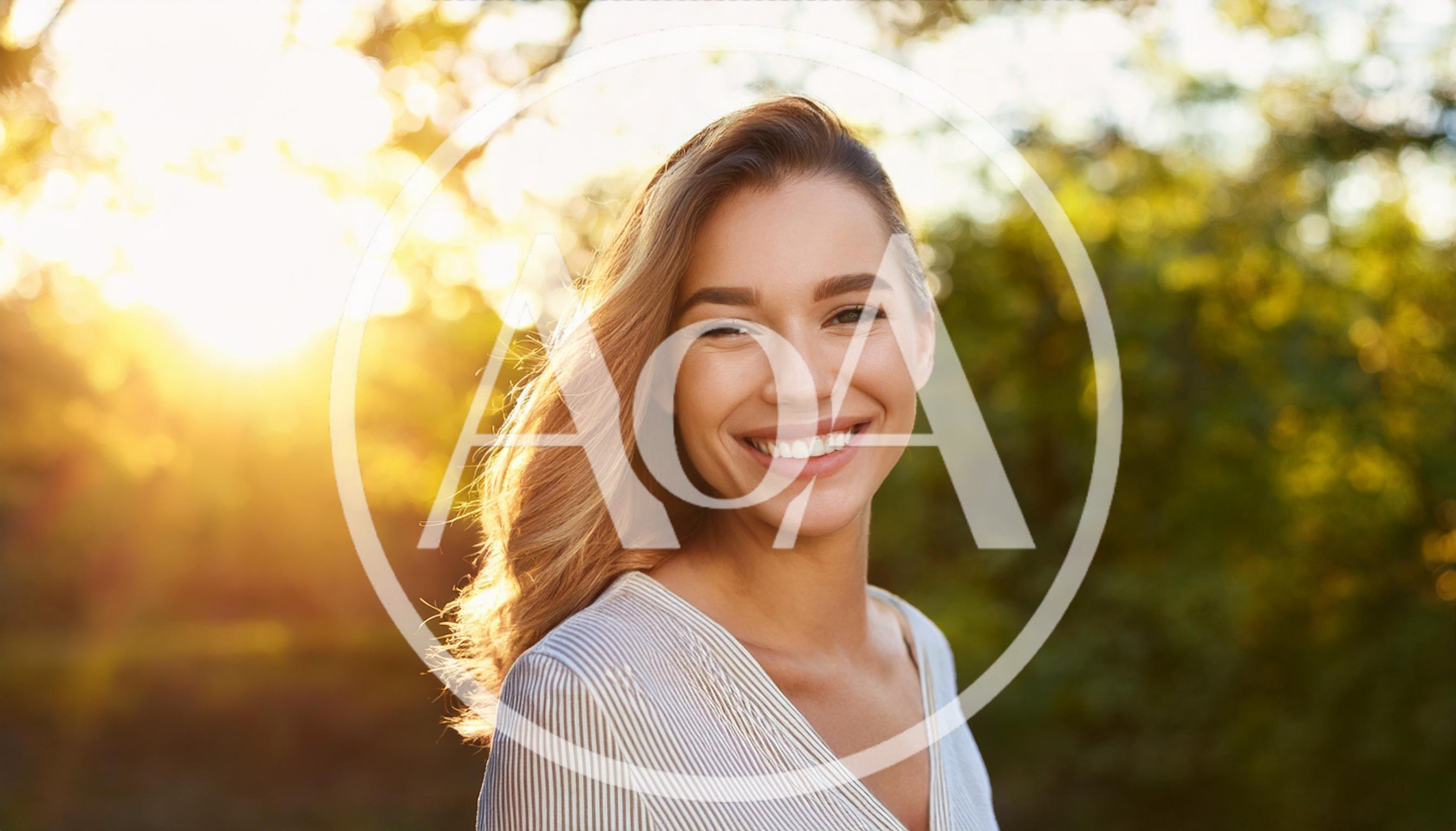 Smiling Young Woman Outdoors During Golden Hour