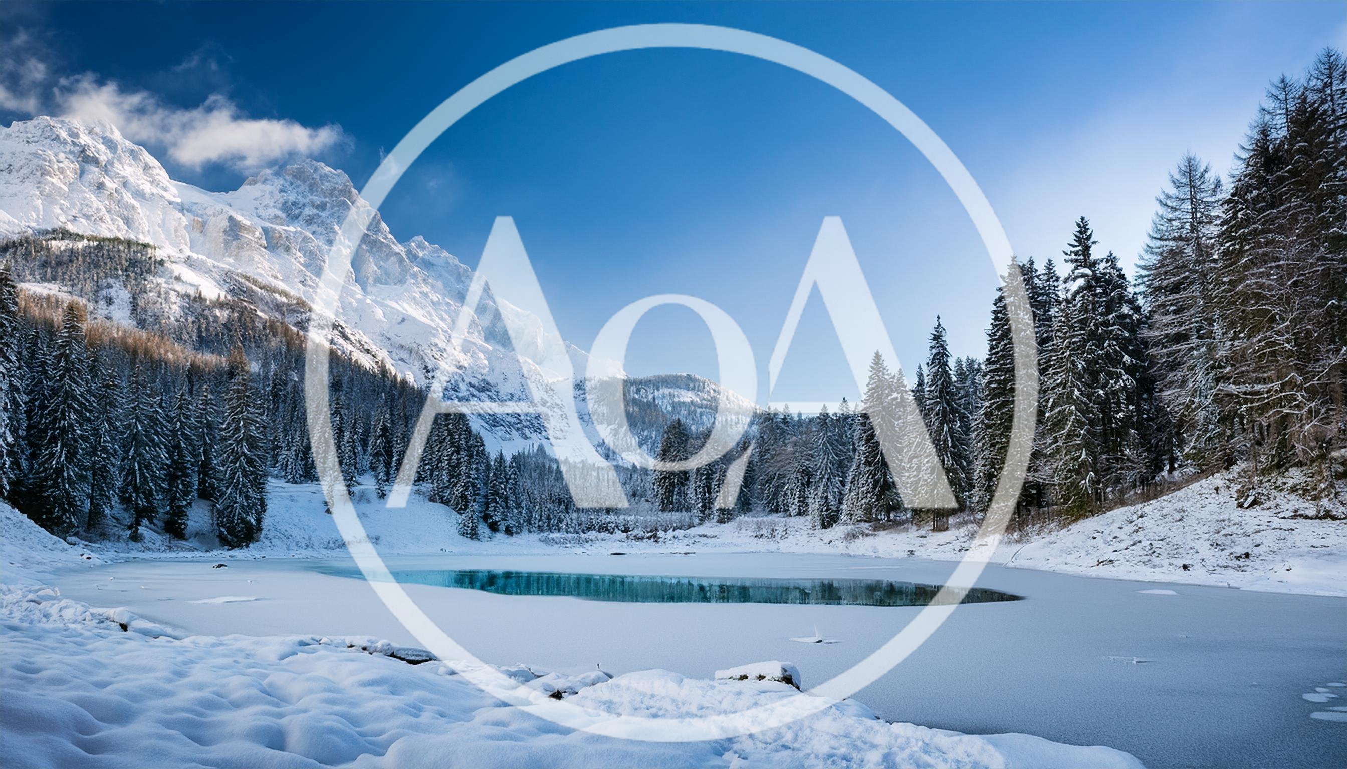 Frozen Alpine Lake With Snow Covered Mountains