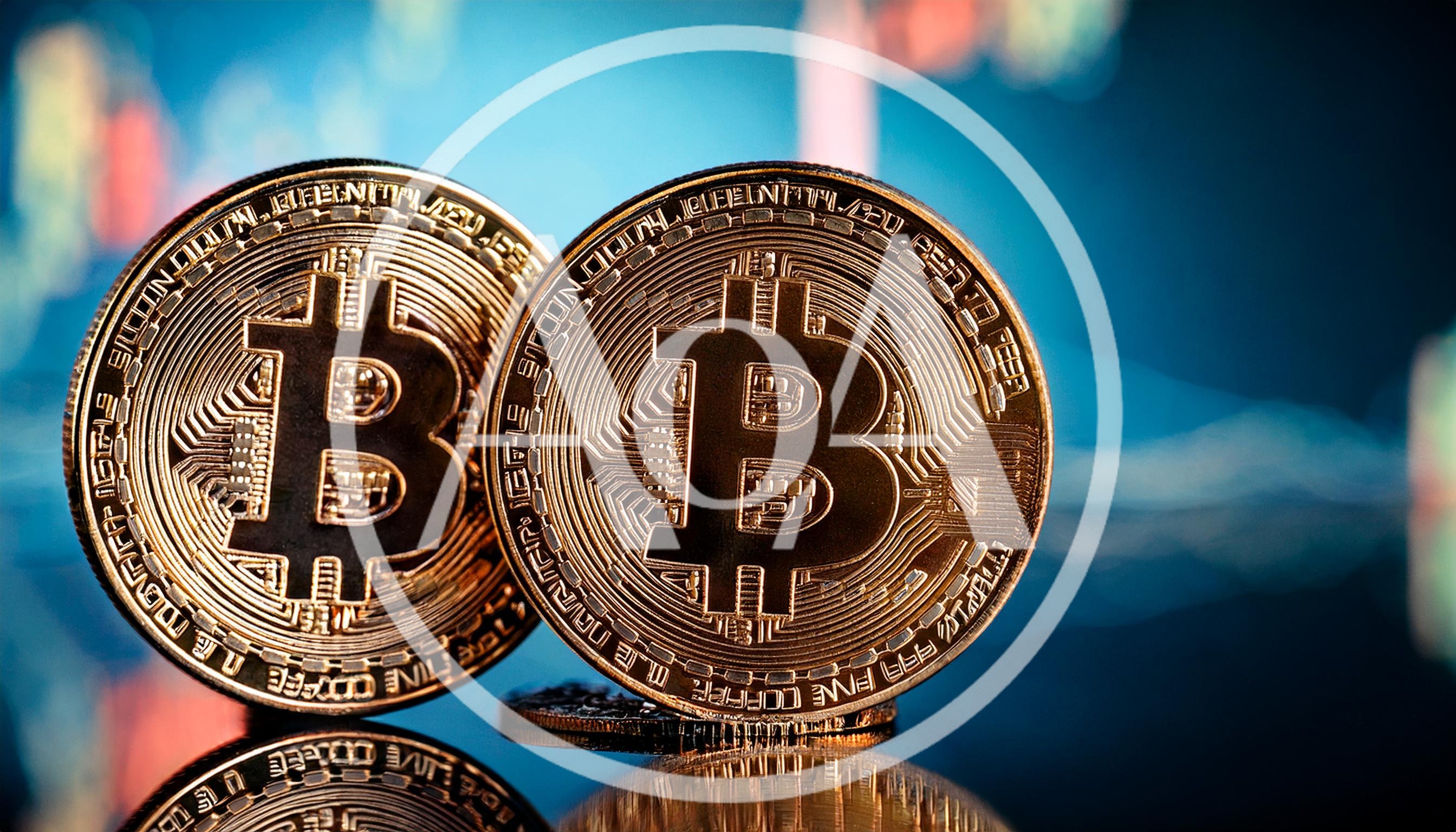 Two Physical Bitcoin Coins Against Digital Trading Chart