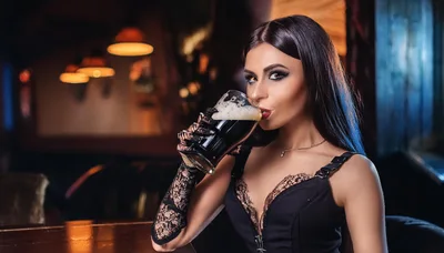 Elegant Woman Drinking Dark Beer In A Pub