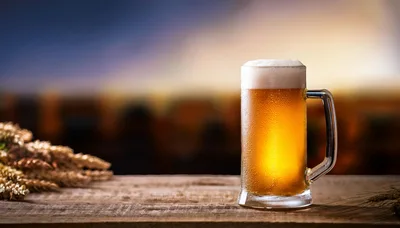 Cold Glass Of Beer On A Wooden Table