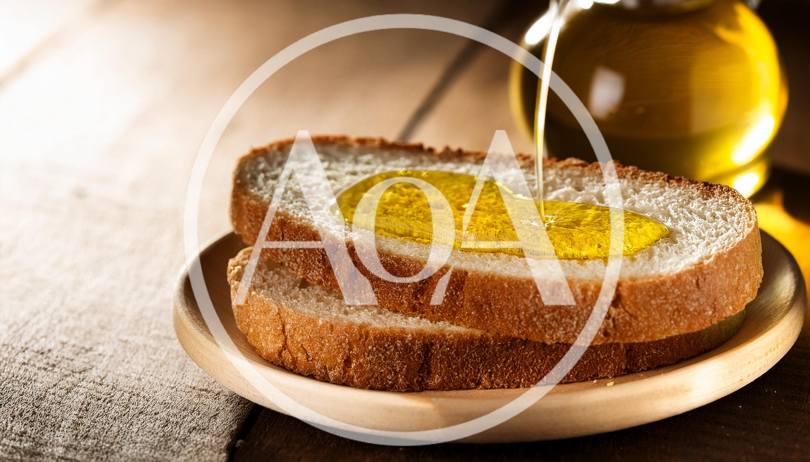 Olive Oil Pouring Over Fresh Slices Of Bread