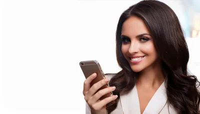 Smiling Businesswoman Using Smartphone Against White Background
