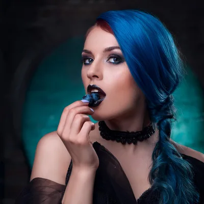 Gothic Woman With Blue Hair Eating Fresh Blueberries