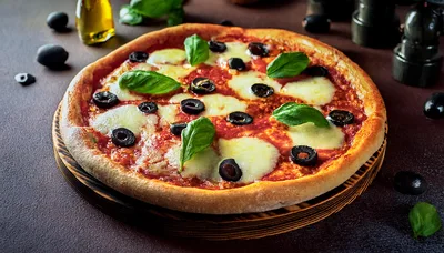Freshly Baked Pizza With Olives And Basil