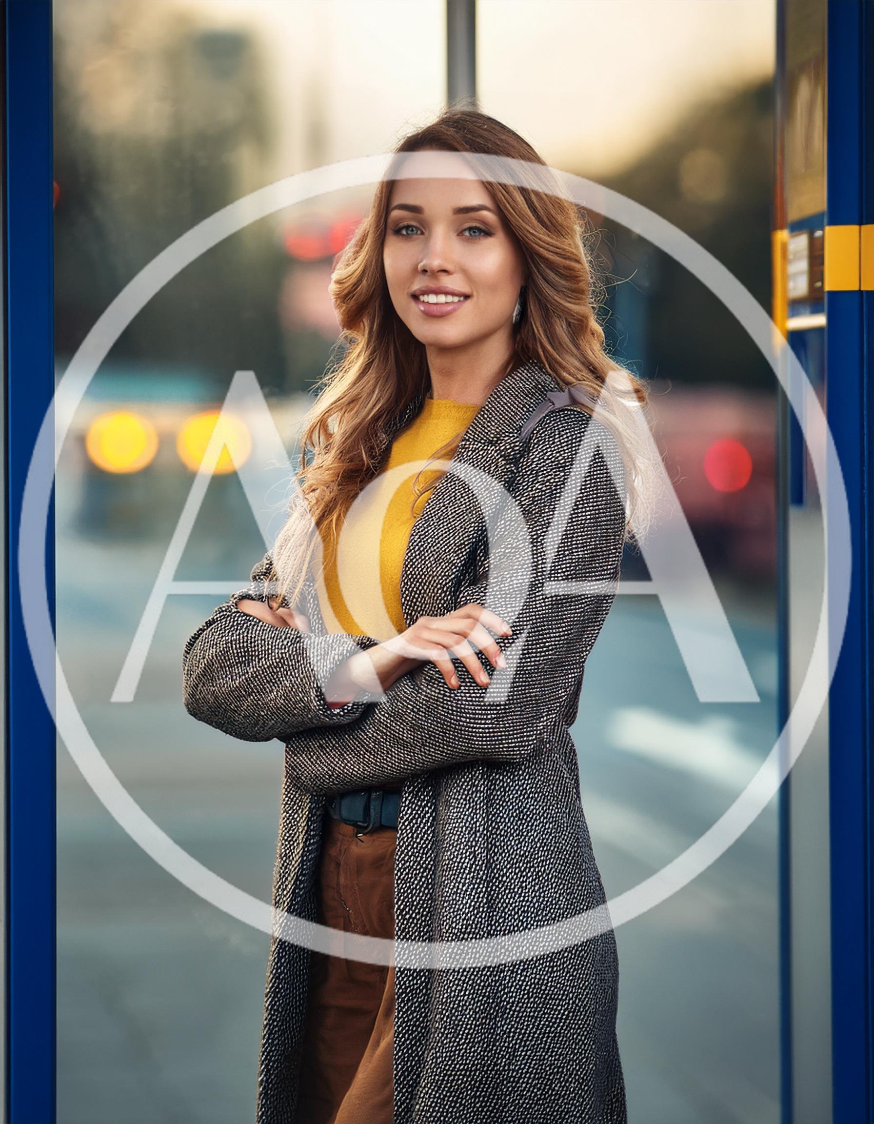 Young Woman Standing At A Bus Stop