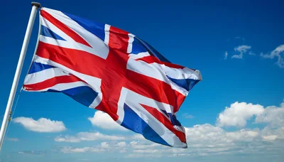 United Kingdom Flag Waving Against Blue Sky