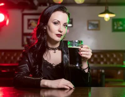 Gothic Woman Holding A Beer Mug In A Pub
