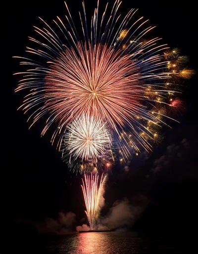 Vibrant Fireworks Display Over Dark Water