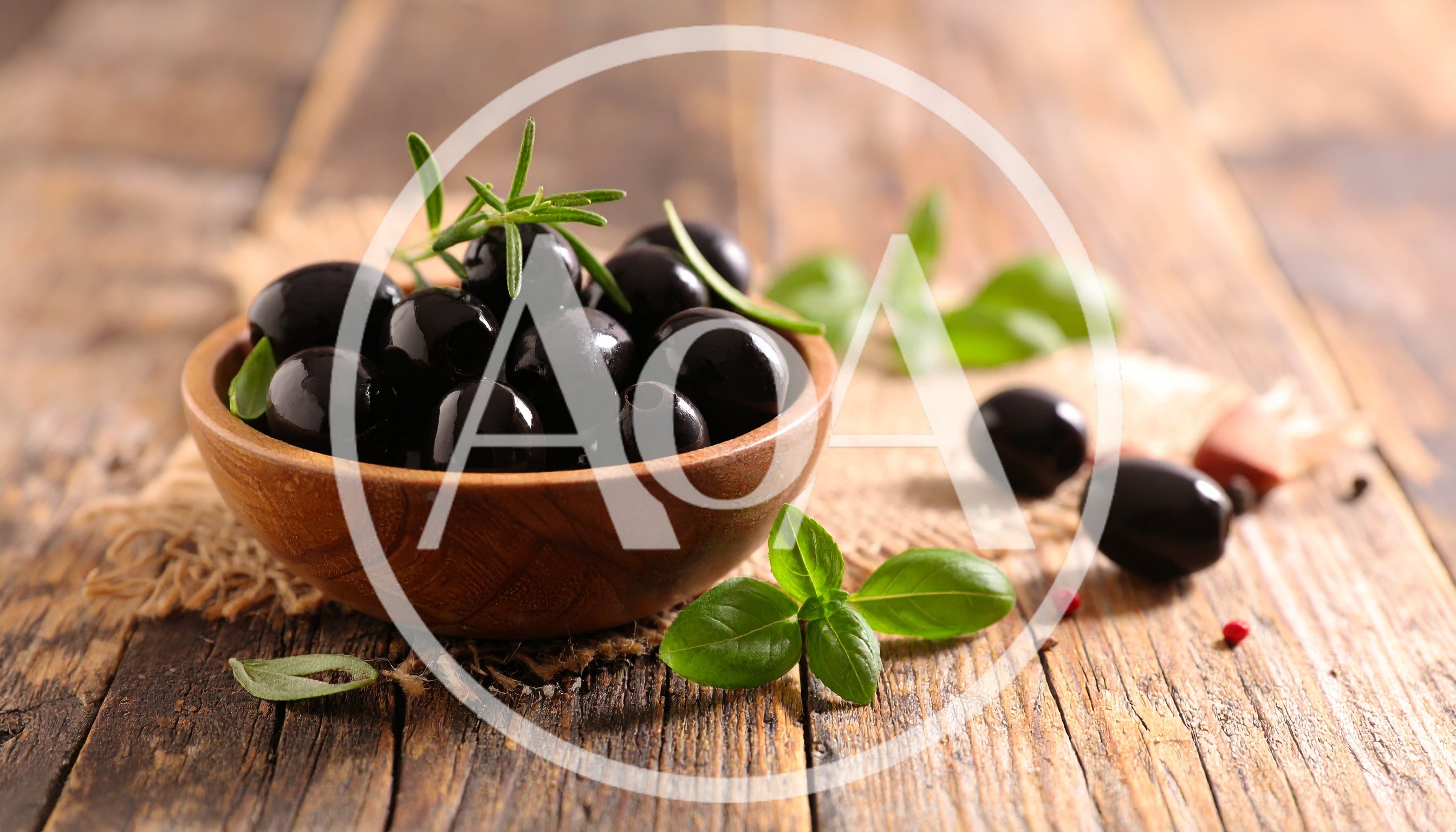 Black Olives in a Wooden Bowl with Herbs