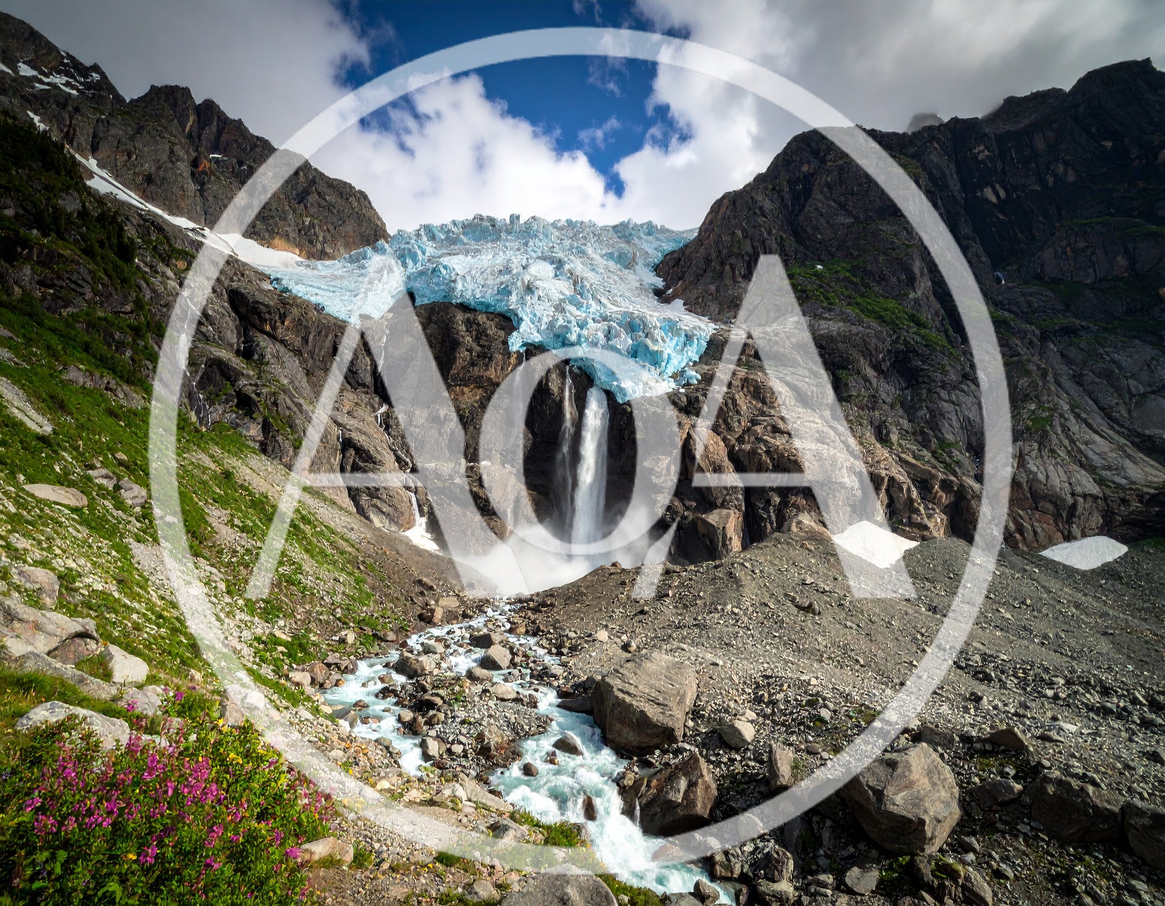 Glacier Waterfall Flowing Down Rugged Mountain Landscape