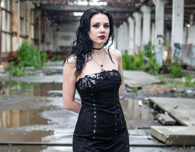 Gothic Woman Standing In An Abandoned Industrial Warehouse