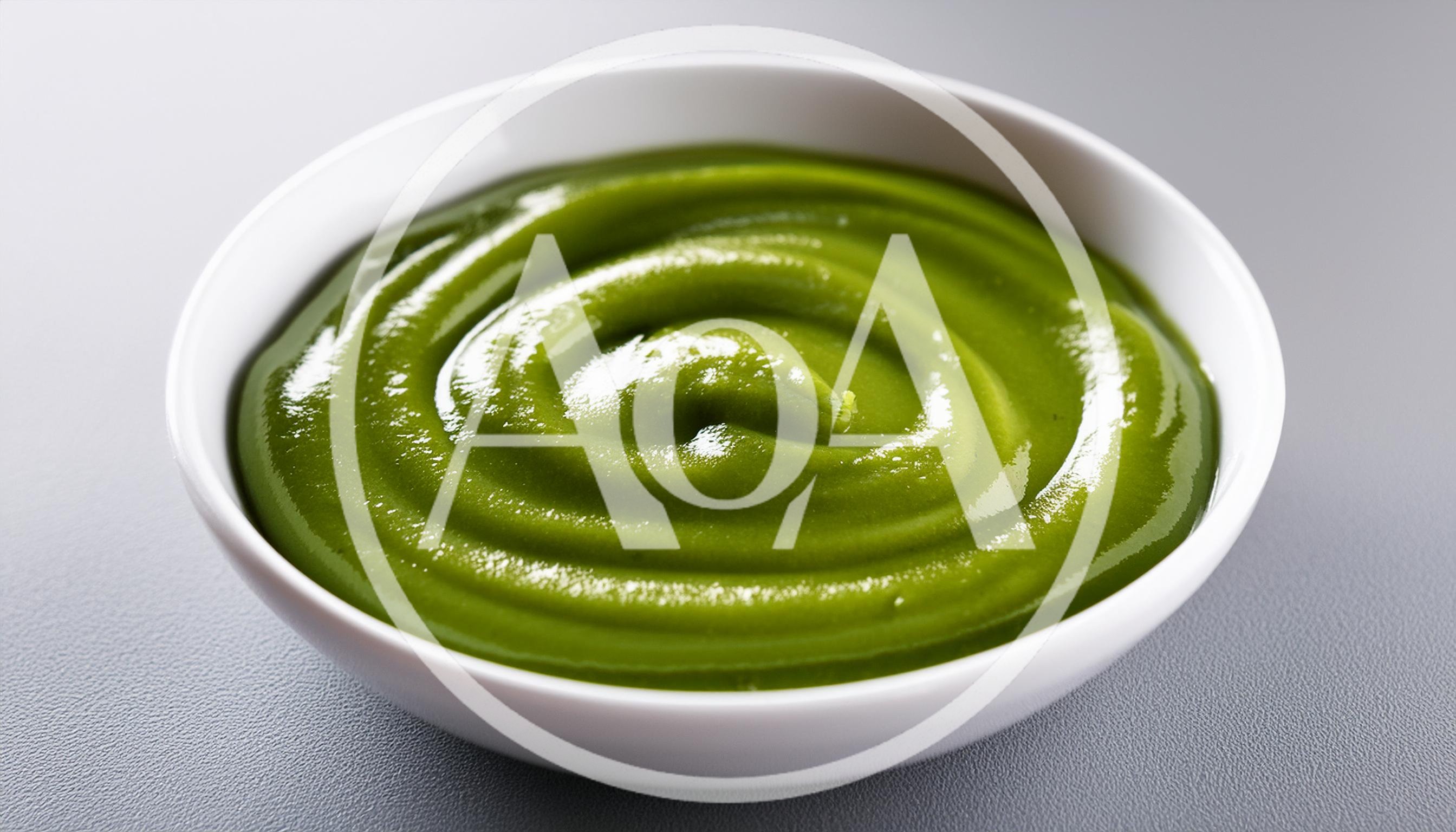 Swirled Green Vegetable Puree In A White Bowl