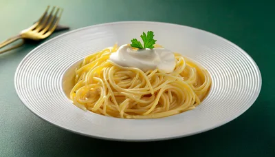 Spaghetti Pasta With Cream Sauce And Parsley Garnish