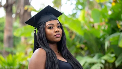 Young Woman Wearing Graduation Cap Outdoors