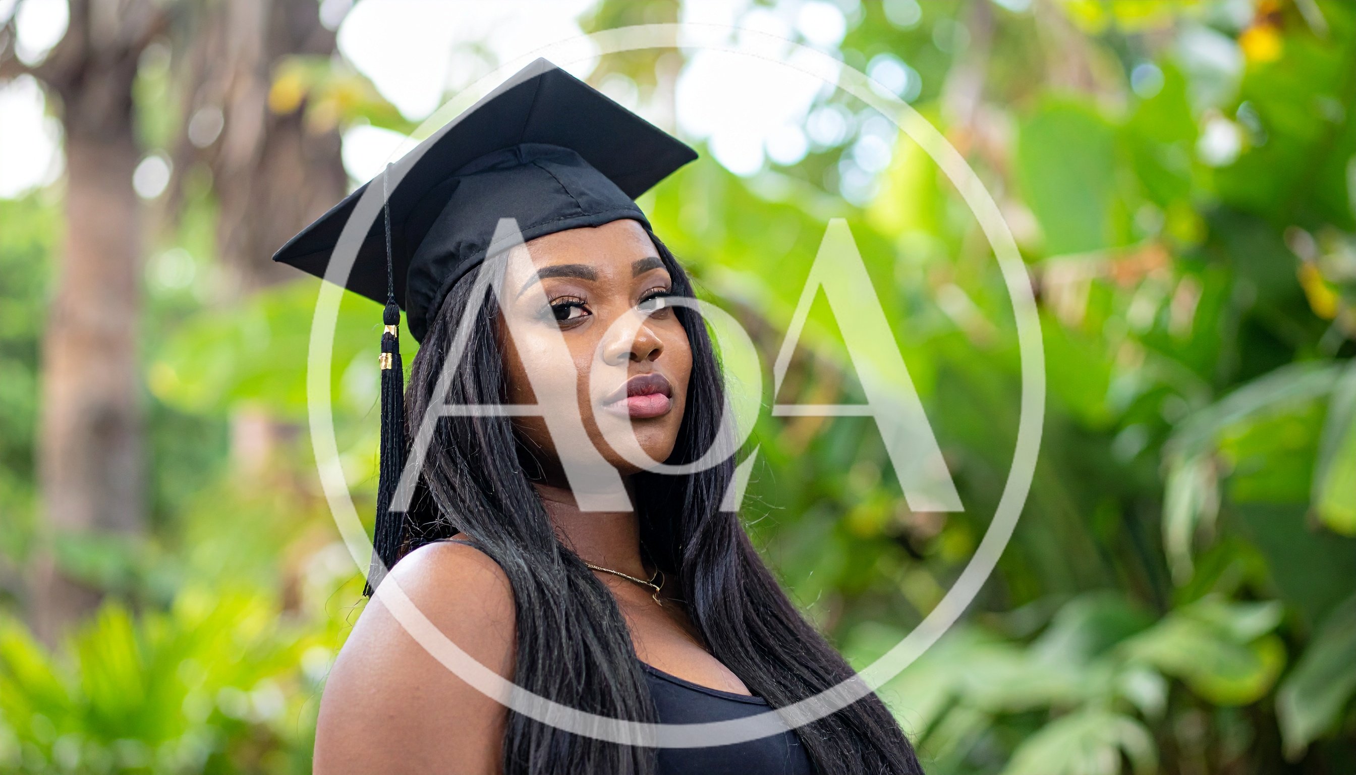 Young Woman Wearing Graduation Cap Outdoors