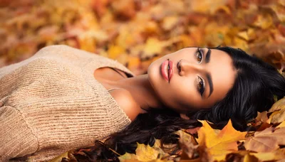 Beautiful Woman Lying In Autumn Leaves