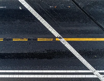 Aerial View Of Asphalt Road With Painted Traffic Markings