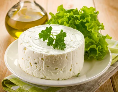 Fresh Round Cheese Wheel With Parsley And Lettuce