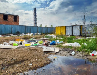 Polluted Industrial Wasteland With Scattered Trash And Debris