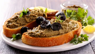 Two Slices Of Toasted Bread With Olive Tapenade