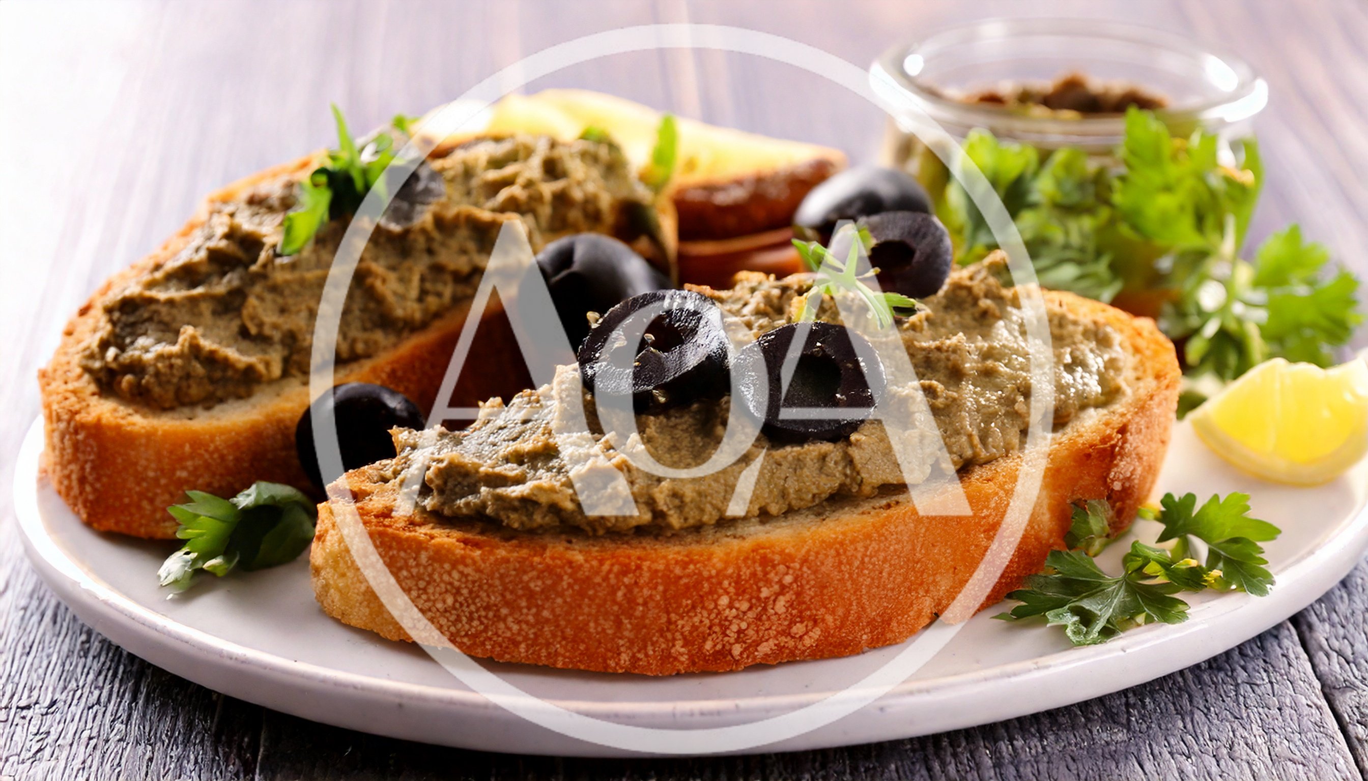 Two Slices Of Toasted Bread With Olive Tapenade