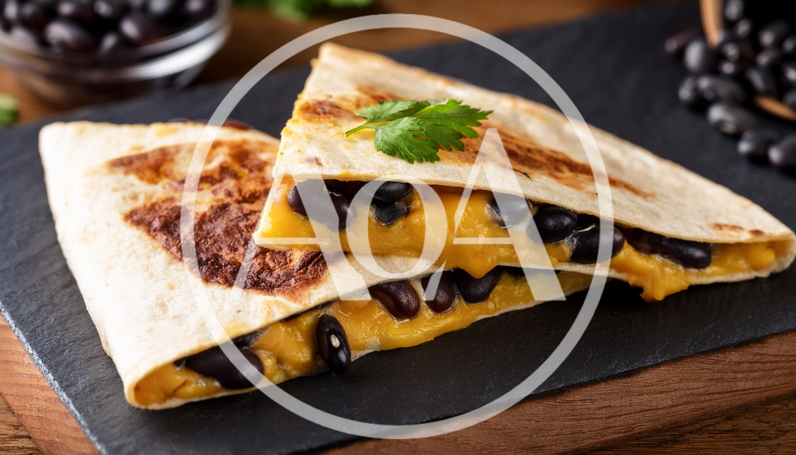 Two Pieces Of Black Bean And Cheese Quesadilla