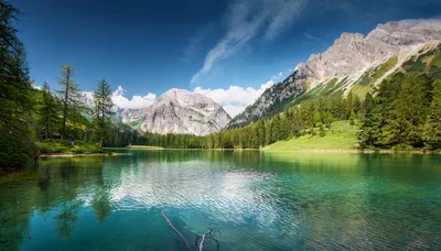 Scenic Alpine Lake With Mountain Peaks And Forest