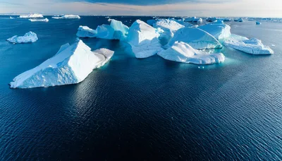 Aerial View Of Massive Icebergs Floating In Arctic Ocean