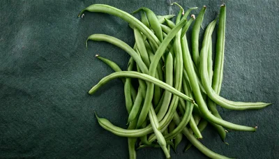 Fresh Green Beans Arranged on Dark Textured Background