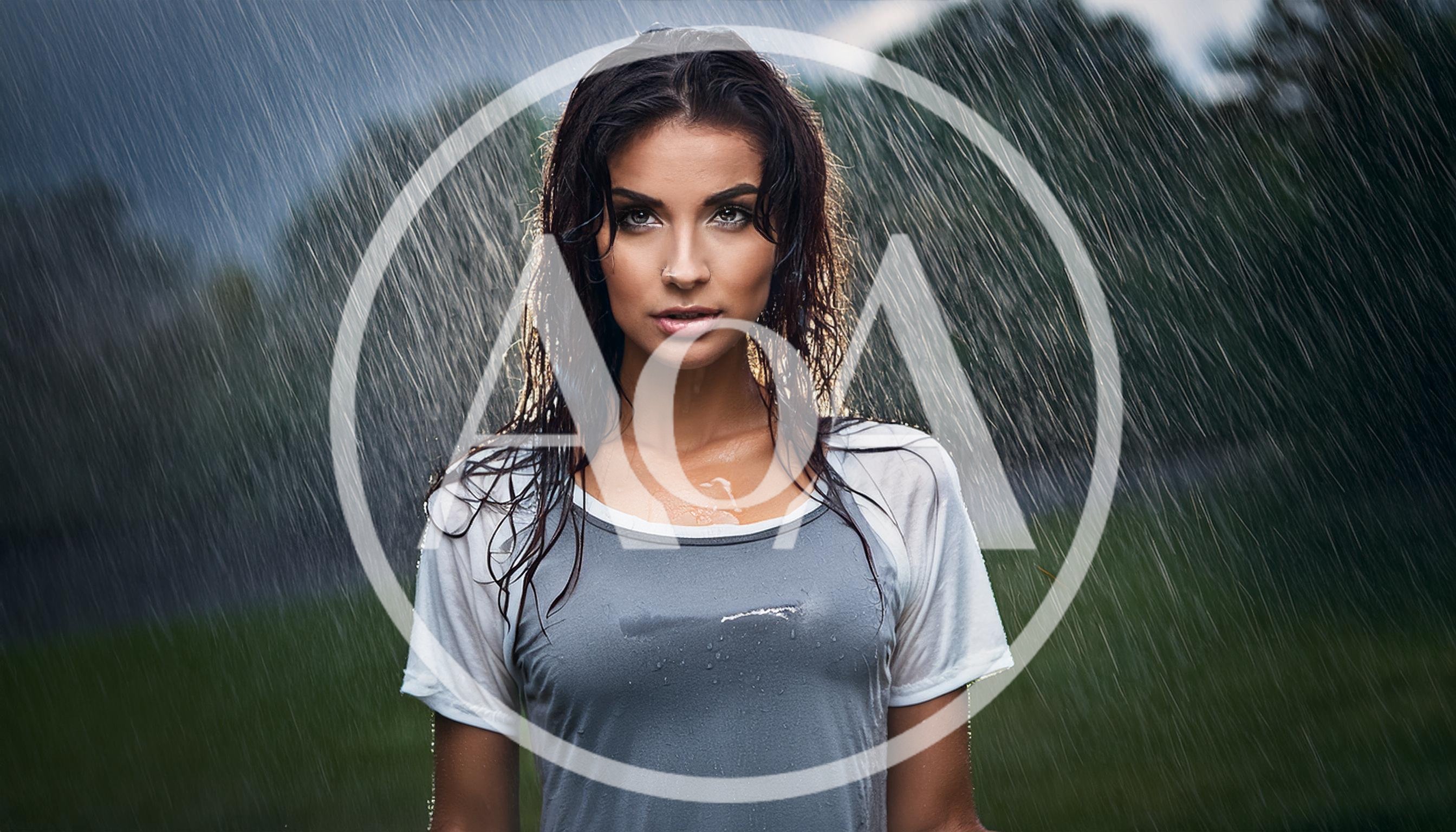Portrait Of A Young Woman Standing In Heavy Rain