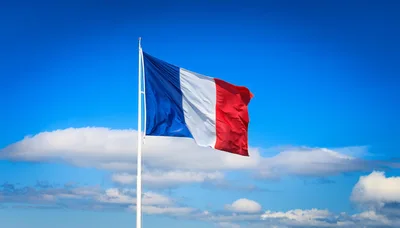 French Flag Waving Against A Clear Blue Sky