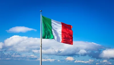 Italian Flag Waving Against A Clear Blue Sky