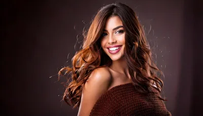 Portrait Of A Smiling Woman With Wavy Brown Hair