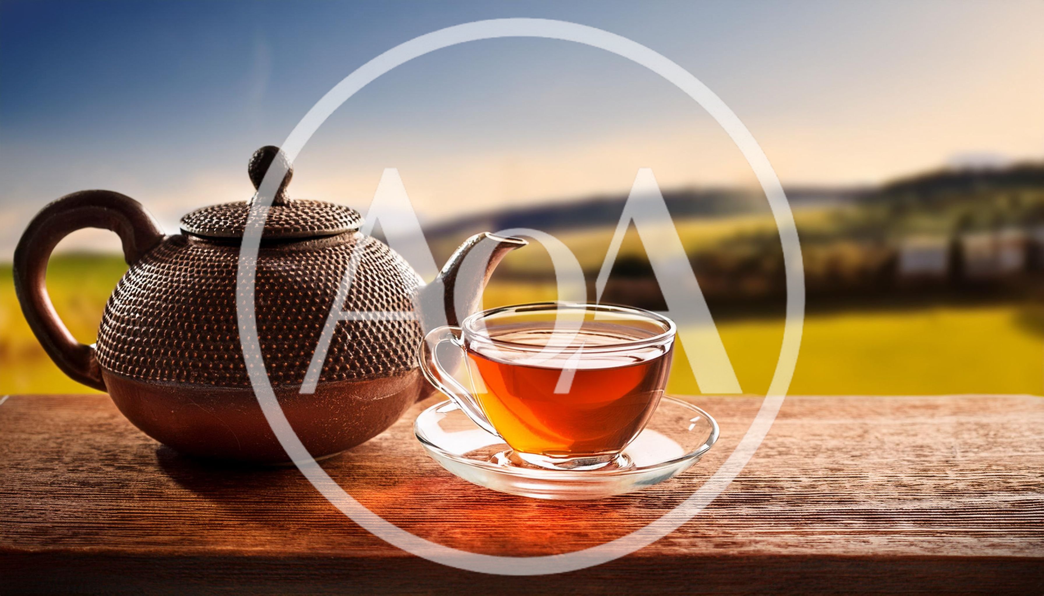 Cast Iron Teapot And Glass Cup On Wooden Table