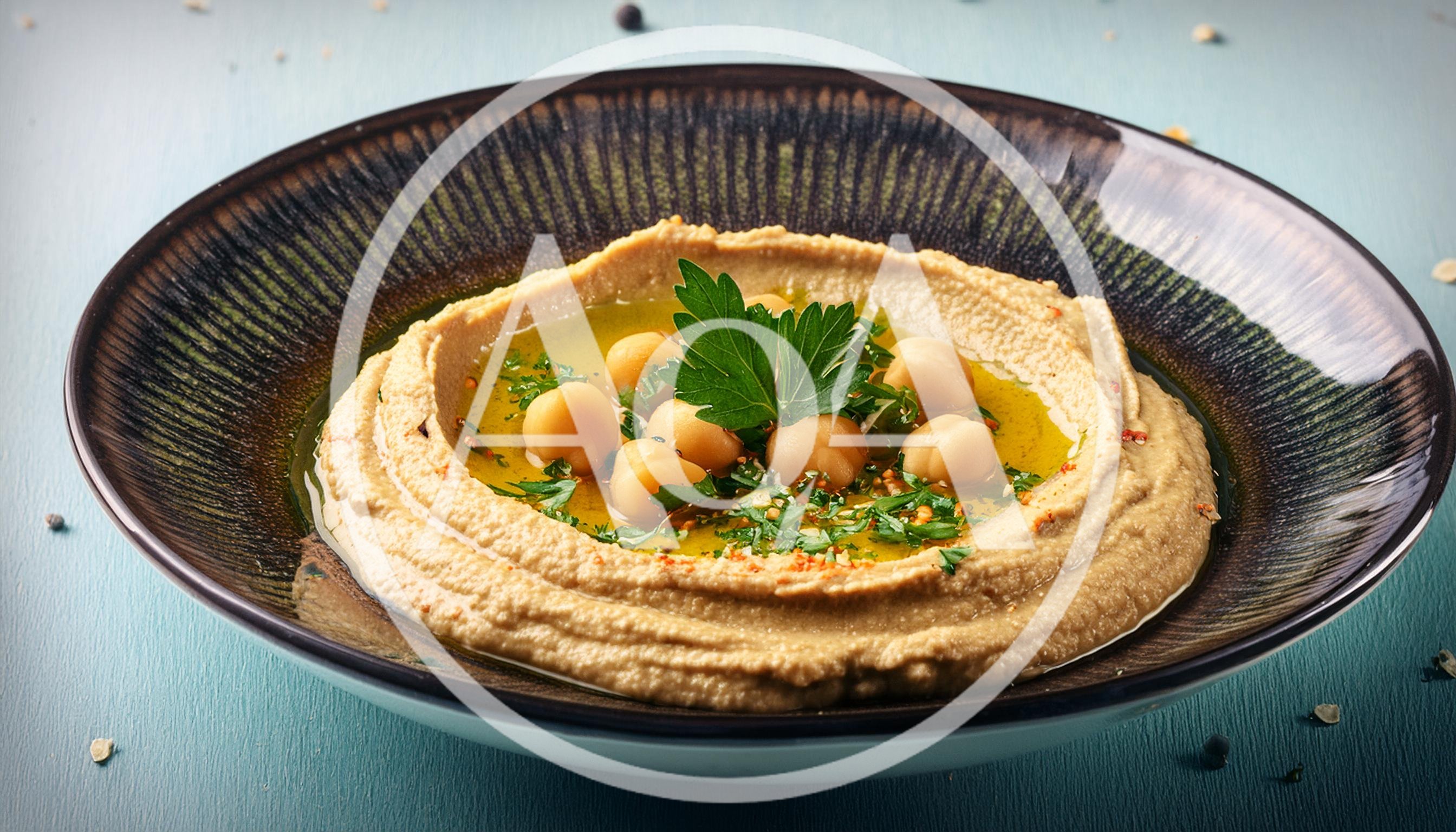 Bowl Of Creamy Hummus With Chickpeas And Parsley