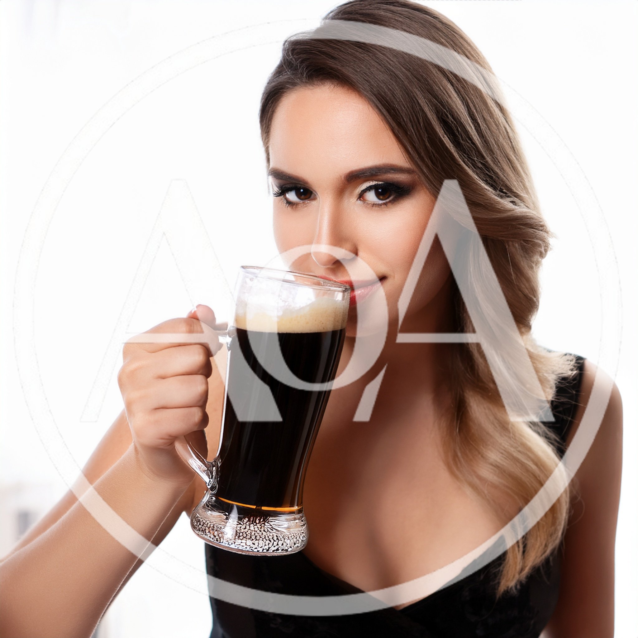 Beautiful Woman Drinking Dark Beer From A Glass Mug