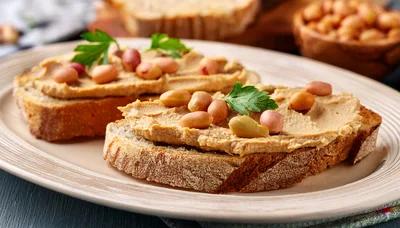 Two Slices Of Bread Topped With Peanut Butter