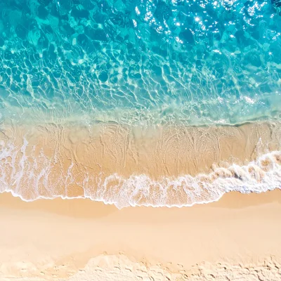 Aerial View Of Tropical Beach Shoreline With Waves