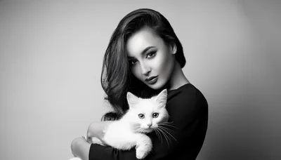 Elegant Woman Holding A Fluffy White Cat